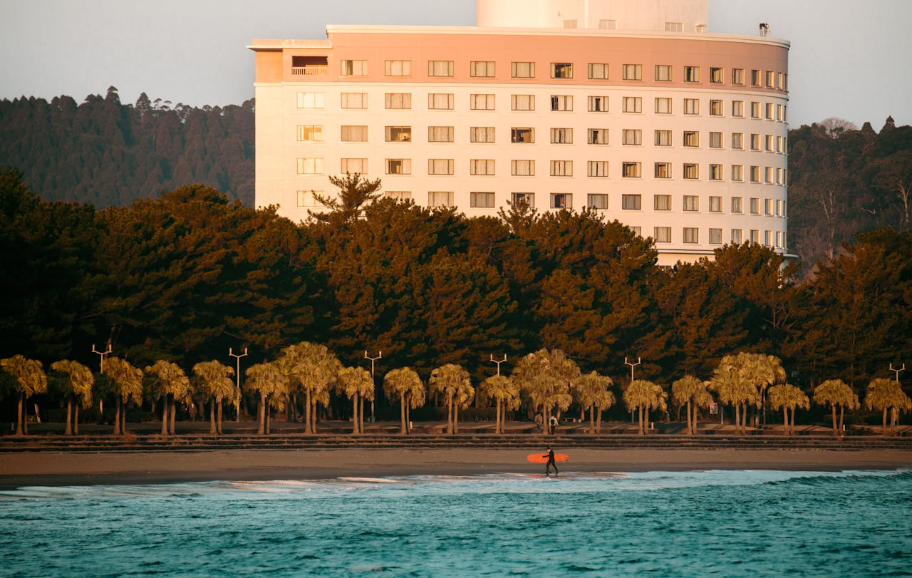 surfer-by-miyazaki-beach-hotel-at-sunrise-29435213